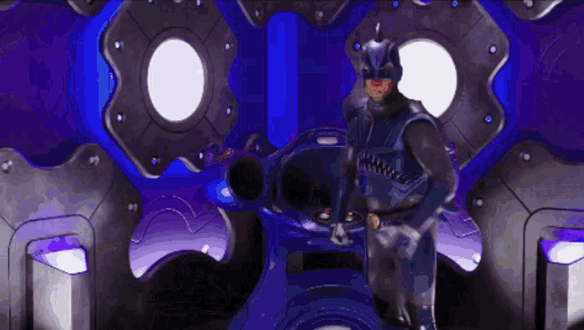 a man in a batman costume is standing in a room