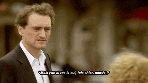 a man in a suit and white shirt is talking to a woman in another language .