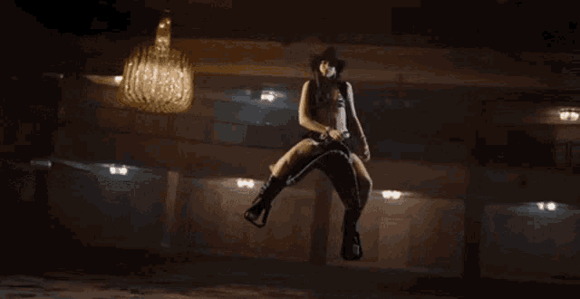 a woman in a cowboy outfit is jumping in the air