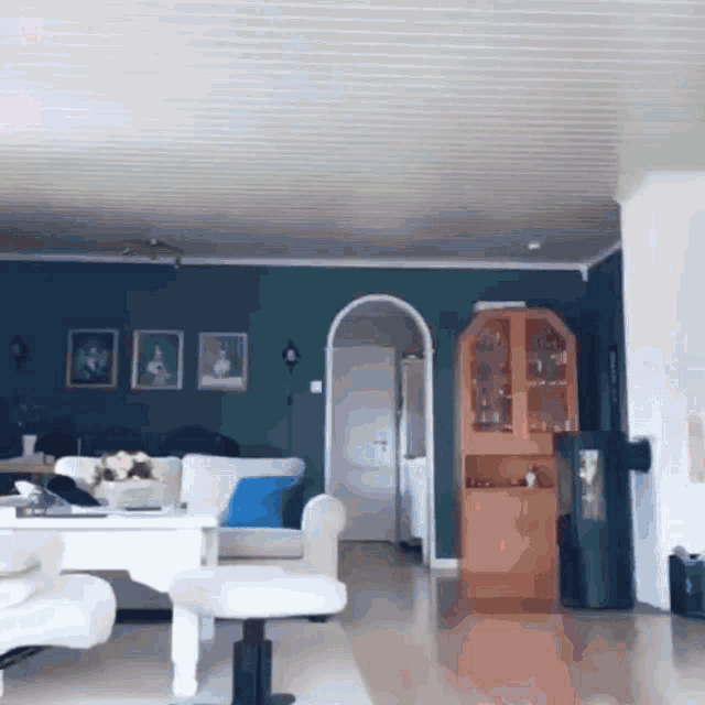 a living room with a white couch and a blue wall