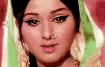 a close up of a woman wearing a nose ring .
