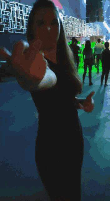 a blurry picture of a woman making a middle finger gesture