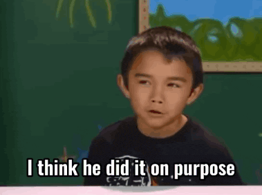 a young boy is sitting at a table and says i think he did it on purpose