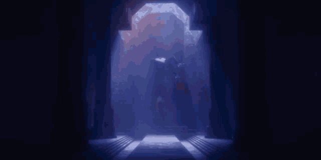a dark hallway with a light coming through the doorway .