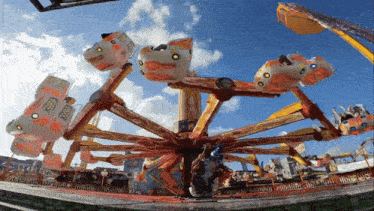 a ferris wheel at an amusement park with a blue sky