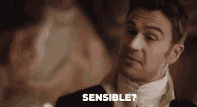 a man in a tuxedo is asking a woman if she is sensitive