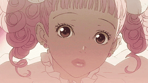 a close up of a woman 's face with pink hair