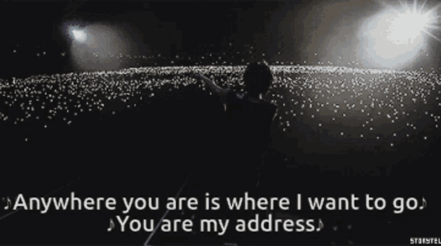 a man stands in front of a crowd with the words anywhere you are is where i want to go
