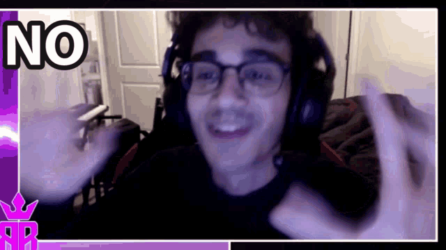 a man wearing headphones and glasses is smiling and making a no sign with his hands