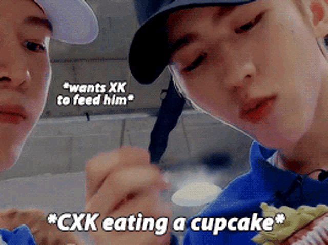 two boys are eating a cupcake and one of them says " wants xk to feed him "