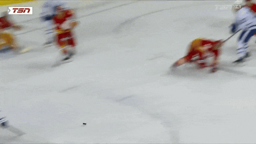 a hockey game is being played in front of a coca cola sign
