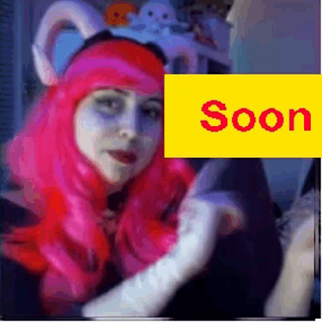 a woman in a pink wig is standing next to a yellow sign that says soon