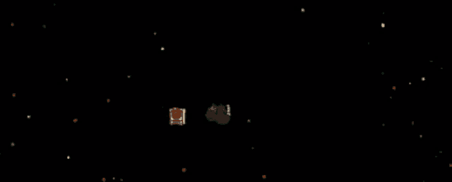a black background with a few red dots and a green object in the middle