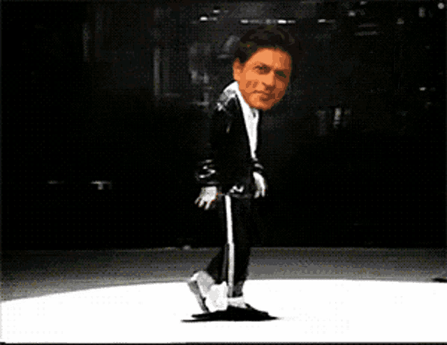 a cartoon of a man in a black suit is dancing on a white surface