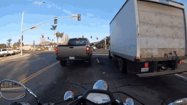 Driving Between Two Cars Motorcyclist GIF - Driving Between Two Cars Motorcyclist Motorcyclist Magazine GIFs