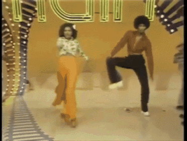 a couple of people are dancing in front of a sign that says ' fun '