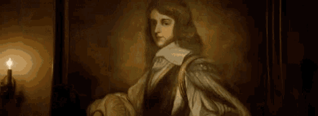 a painting of a man in a robe is hanging on a wall next to two candles .