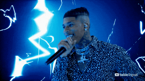 a man singing into a microphone with a youtube originals logo in the background