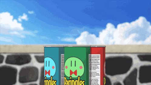 three cans of pringles are lined up in front of a stone wall