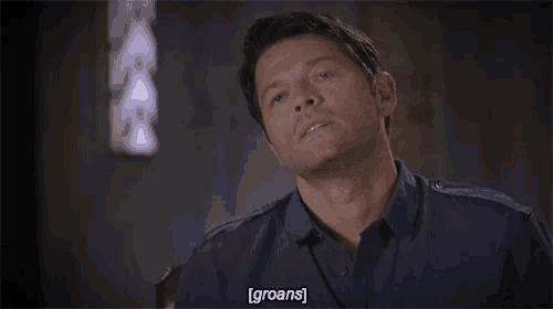 a man in a blue shirt is sitting in a chair and says groans