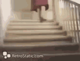 a woman in a red dress is walking up a set of stairs