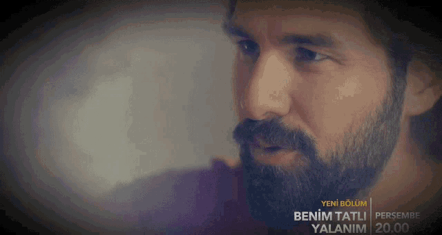 a man with a beard is shown on a screen that says benim tatli