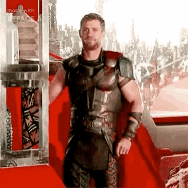 a man in a superhero costume is standing in front of a window .