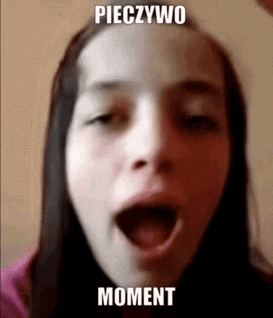 a close up of a girl 's face with her mouth open and the words pieczywo moment written above her mouth .