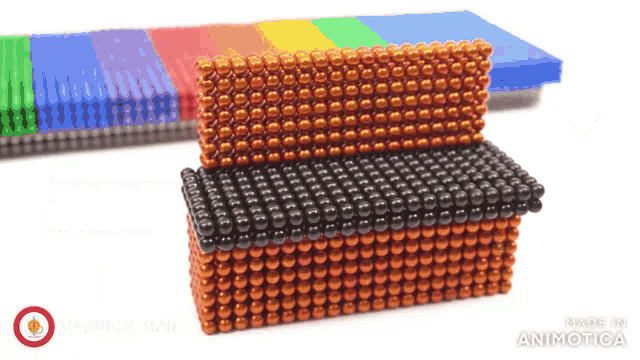a bunch of magnets are stacked on top of each other on a table