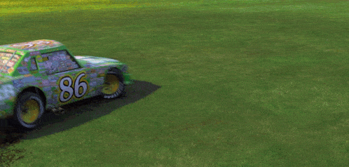 a green car is driving on a grassy field