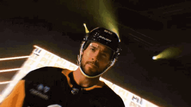 a hockey player is wearing a bauer helmet