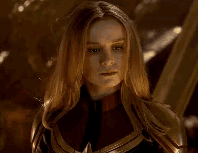 a close up of a woman in a captain marvel costume looking at the camera .