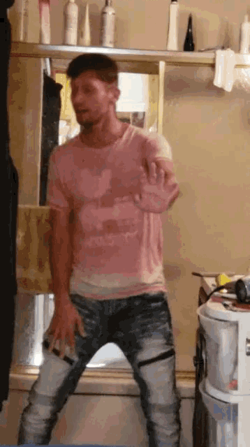 a man wearing a pink shirt that says milk shop on it