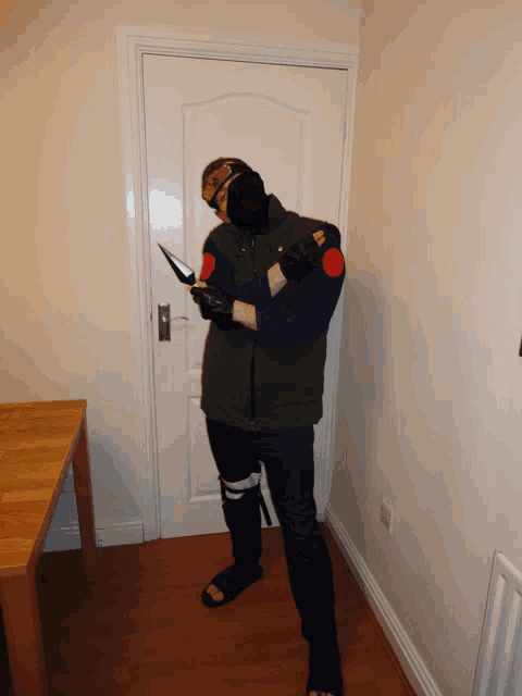 a man in a costume is standing in a hallway
