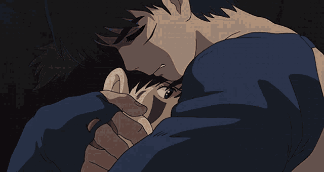 a man in a blue shirt is hugging a child
