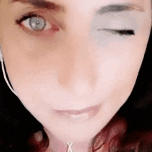 a close up of a woman 's face with her eye closed