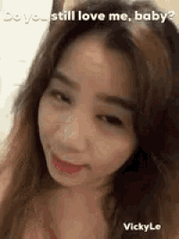a woman with long hair is smiling and looking at the camera .