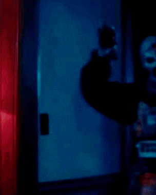 a clown with blood on his face is holding a pot with a floral design on it