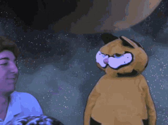 a cartoon character named garfield is standing in front of a man