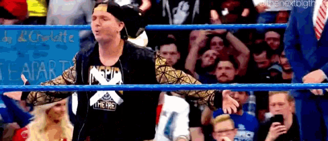 a man in a wrestling ring is wearing a shirt that says nspin on it