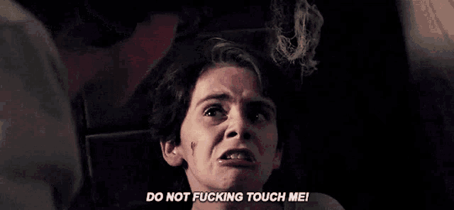 a young boy is laying in a chair and saying `` do not touch me '' .