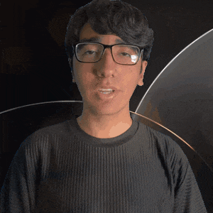 a man wearing glasses and a sebastian shirt looks at the camera