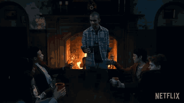 a group of people sitting around a fireplace with a netflix logo on the bottom