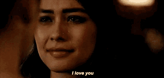 a woman is crying and saying `` i love you '' while a man looks on .