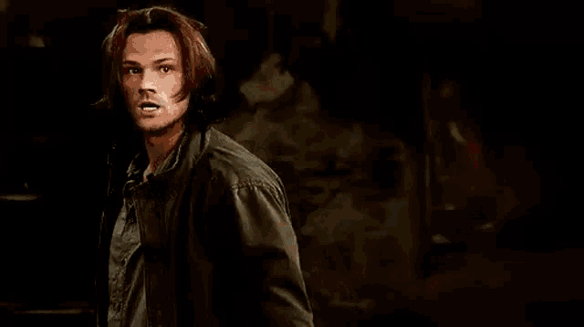a man is holding a large hammer in his hand .