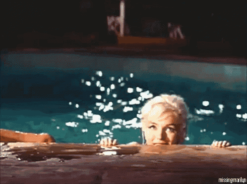 a woman is swimming in a pool with the words " missingmarilyn " below her
