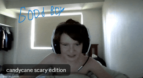 a boy wearing headphones with candycane scary edition written in blue