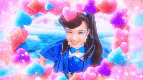 a girl in a blue dress is surrounded by pink hearts and smiling .