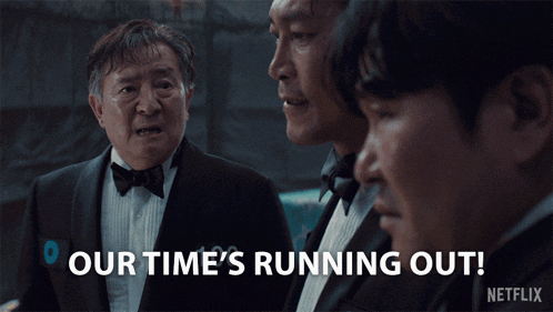 a man in a tuxedo says " our time 's running out " in front of two other men