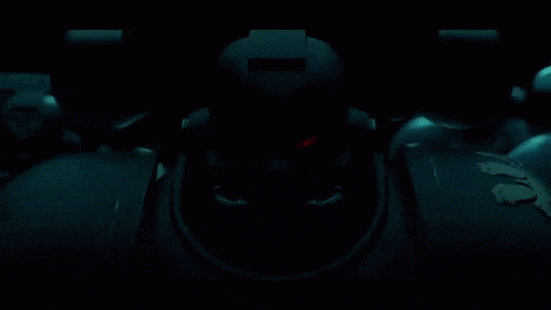a dark room with a red light that says ' emergency ' on it